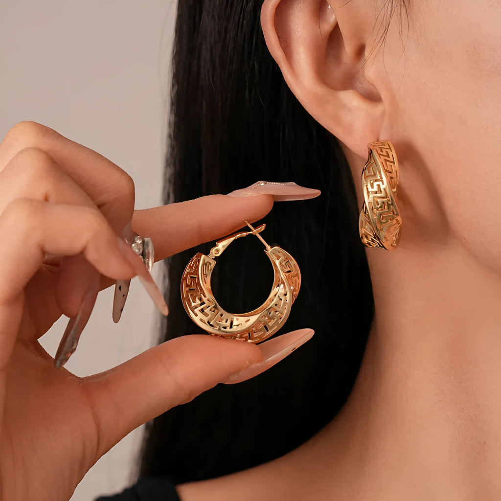 Women's geometric hollow stud earrings with twisted round design in gold or silver finish
