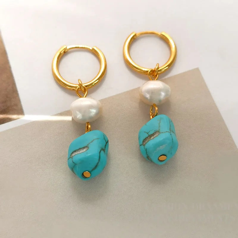 Geometric irregular shaped copper clip-on earrings with turquoise stones and cultured pearls.