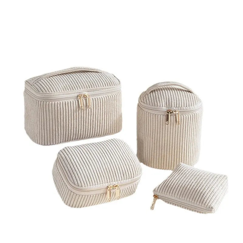 Four cube-shaped flannelette makeup bags in different colours including pink, khaki, pink dots, and blue with dots