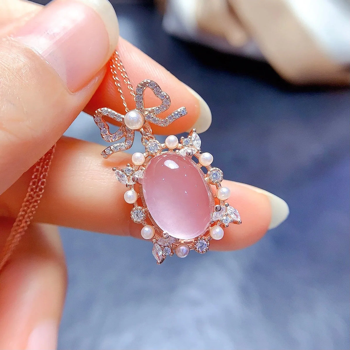 Geometric rose quartz pendant on a silver chain with rose gold plating