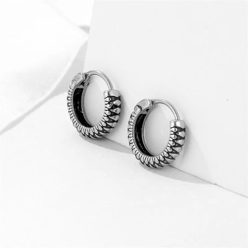 Silver geometric earrings with a retro twist striped pattern, made from titanium steel.