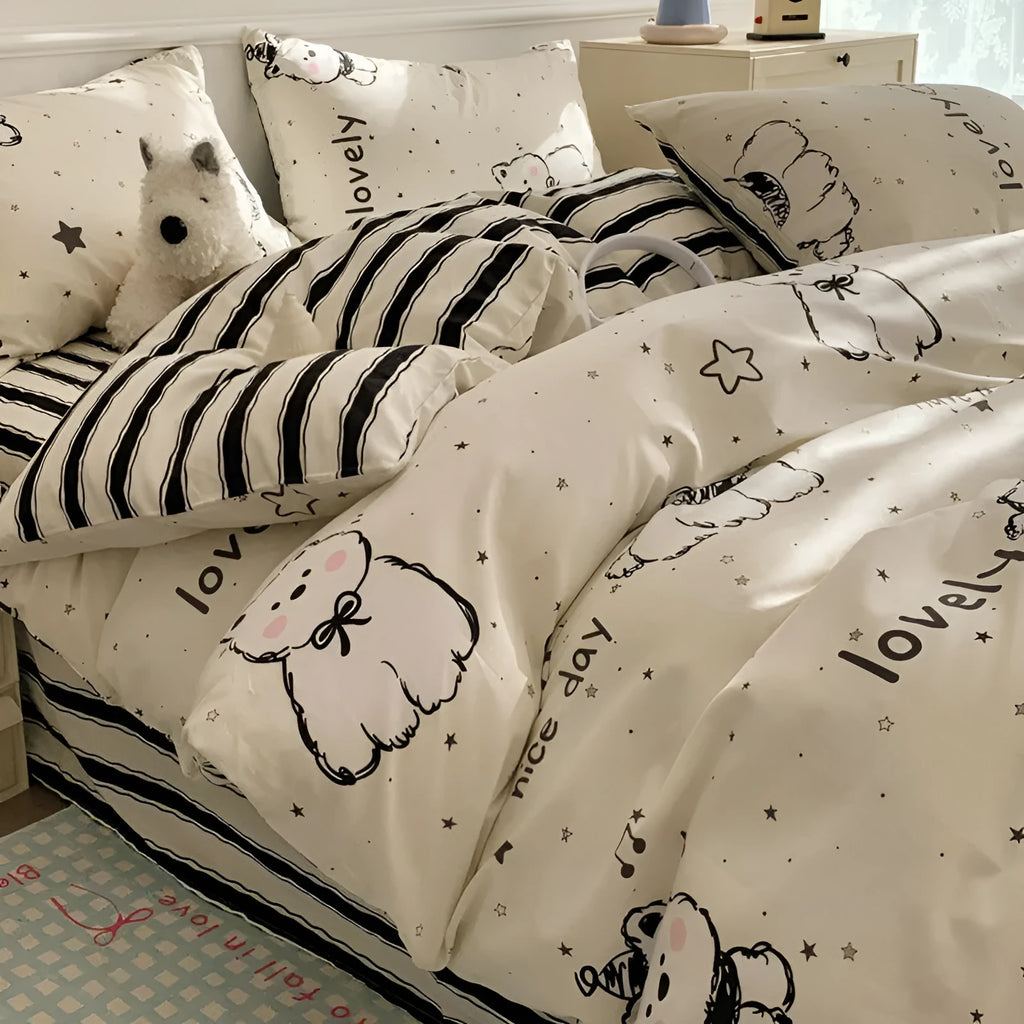 Cartoon dog patterned cotton four-piece bedding set laid on a bed.