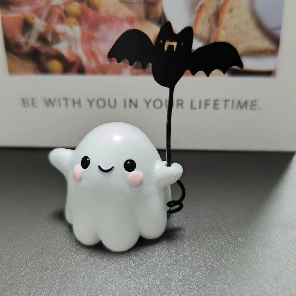 Small resin statue of a ghost dog with a bat, a miniature Halloween ornament.