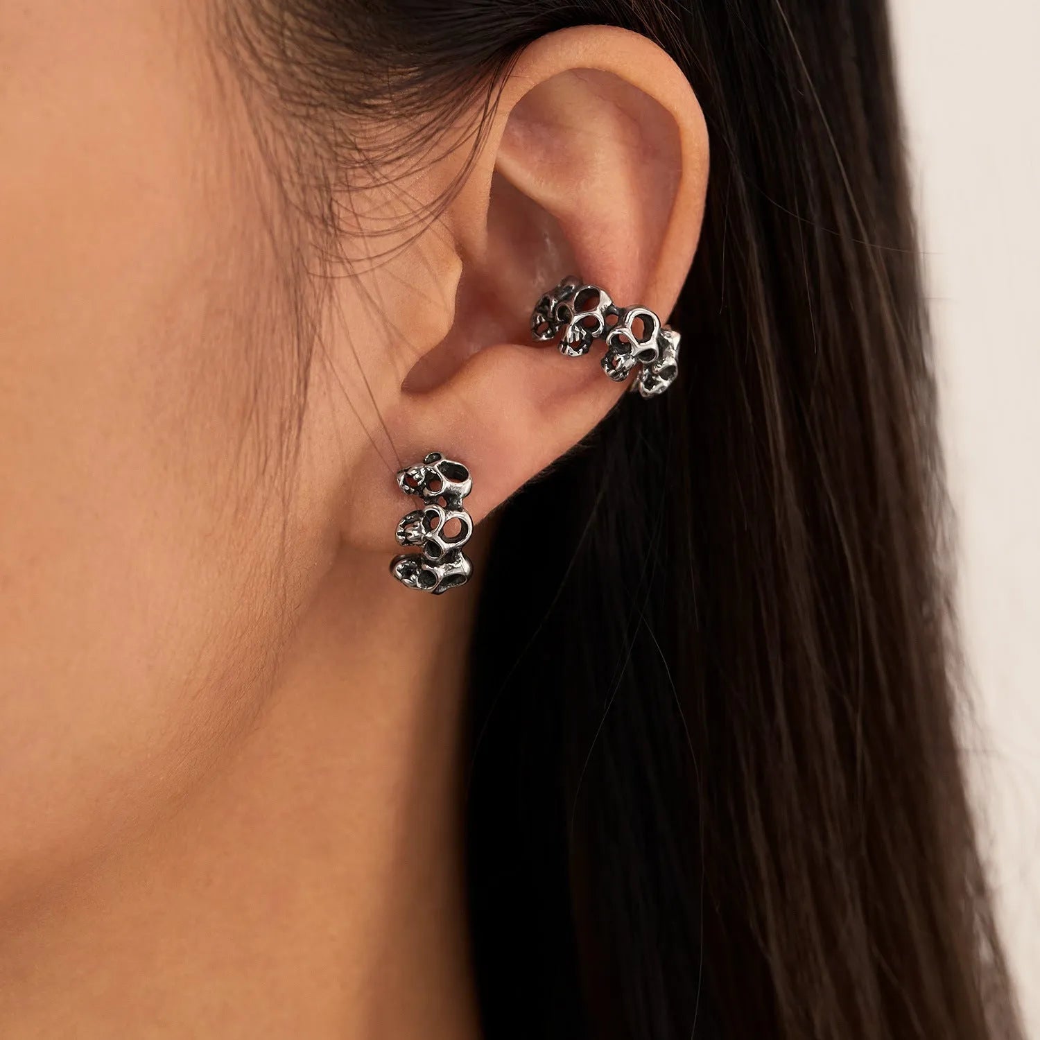 Retro geometric skull earrings in stainless steel with ear clip fitting.