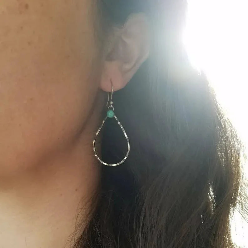 A pair of vintage-style bohemian circle earrings in antique silver alloy with turquoise colour accents.