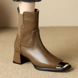Brown high-heel Martin boots made of cowhide leather with a side zipper closure.