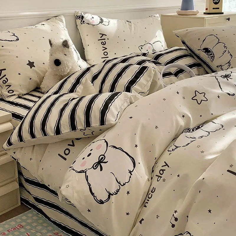 Cartoon dog patterned cotton four-piece bedding set laid on a bed.
