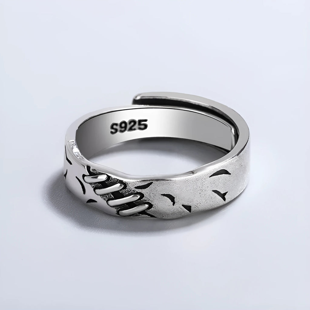 Black copper geometric ring with adjustable opening and round oval design elements.