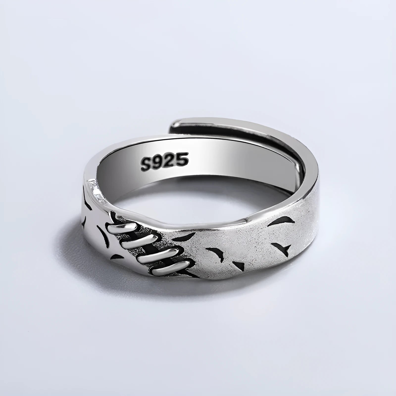 Black copper geometric ring with adjustable opening and round oval design elements.