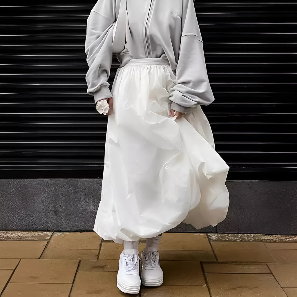 Women's solid colour cotton long skirt on a hanger, available in black or white.