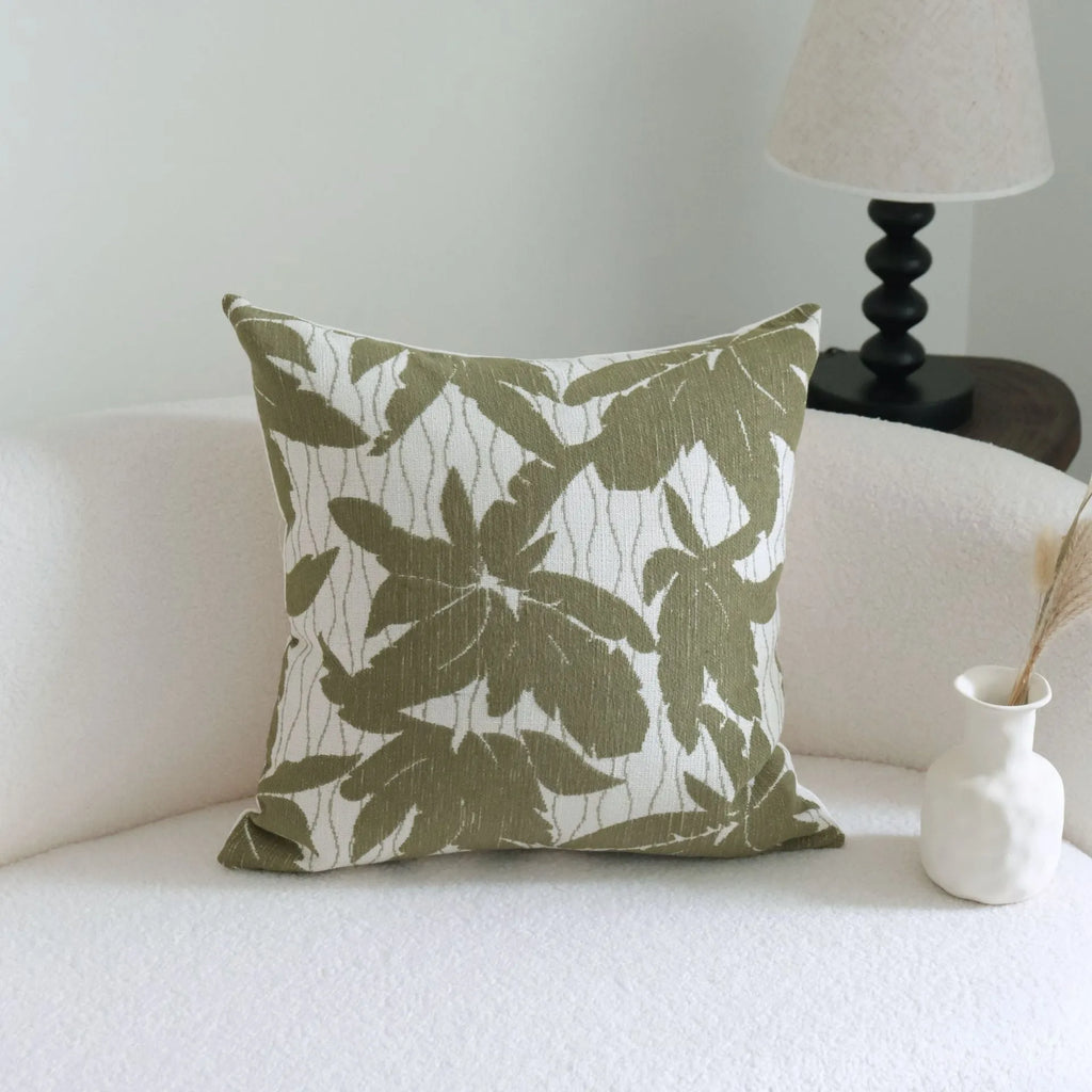Green striped and botanical pattern decorative pillow set with tassel detail for hotel sample rooms.