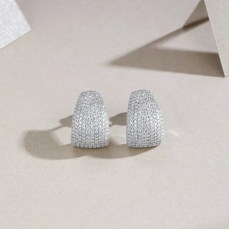 Geometric shaped sterling silver stud earrings with a white moissanite stone.