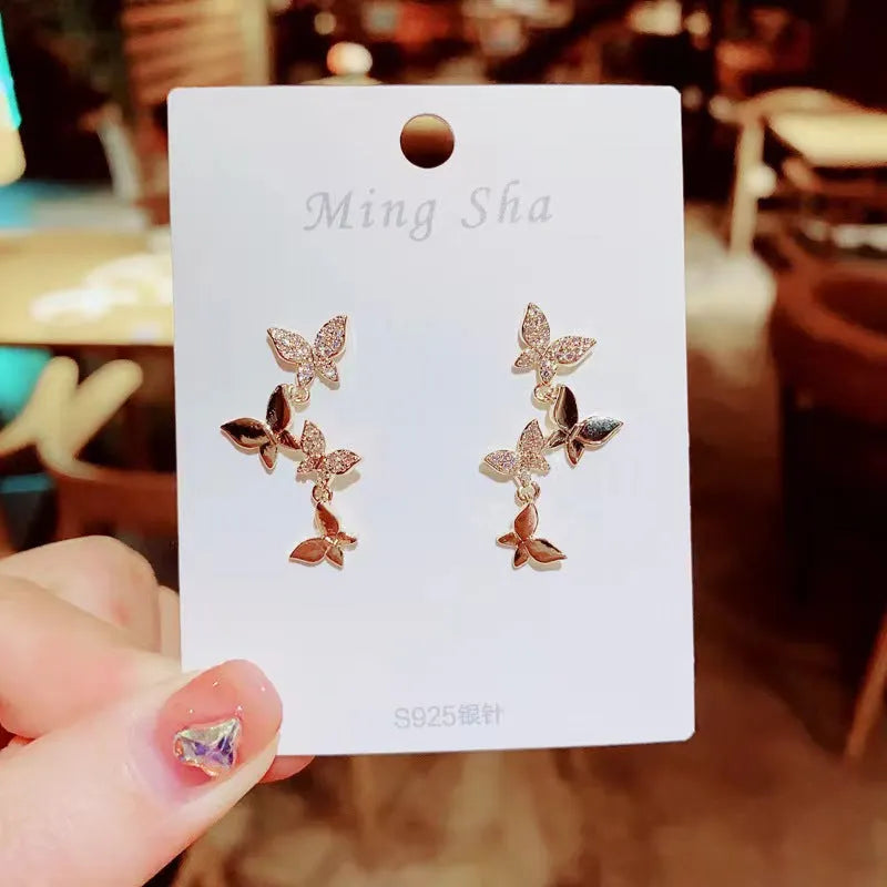 Women's copper butterfly earrings with four butterfly design and gold-coloured drops