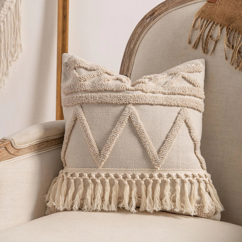 Knitted striped cushion cover with tassel detail in spiral dots design, shown in 45x45cm size.