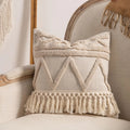 Knitted striped cushion cover with tassel detail in spiral dots design, shown in 45x45cm size.