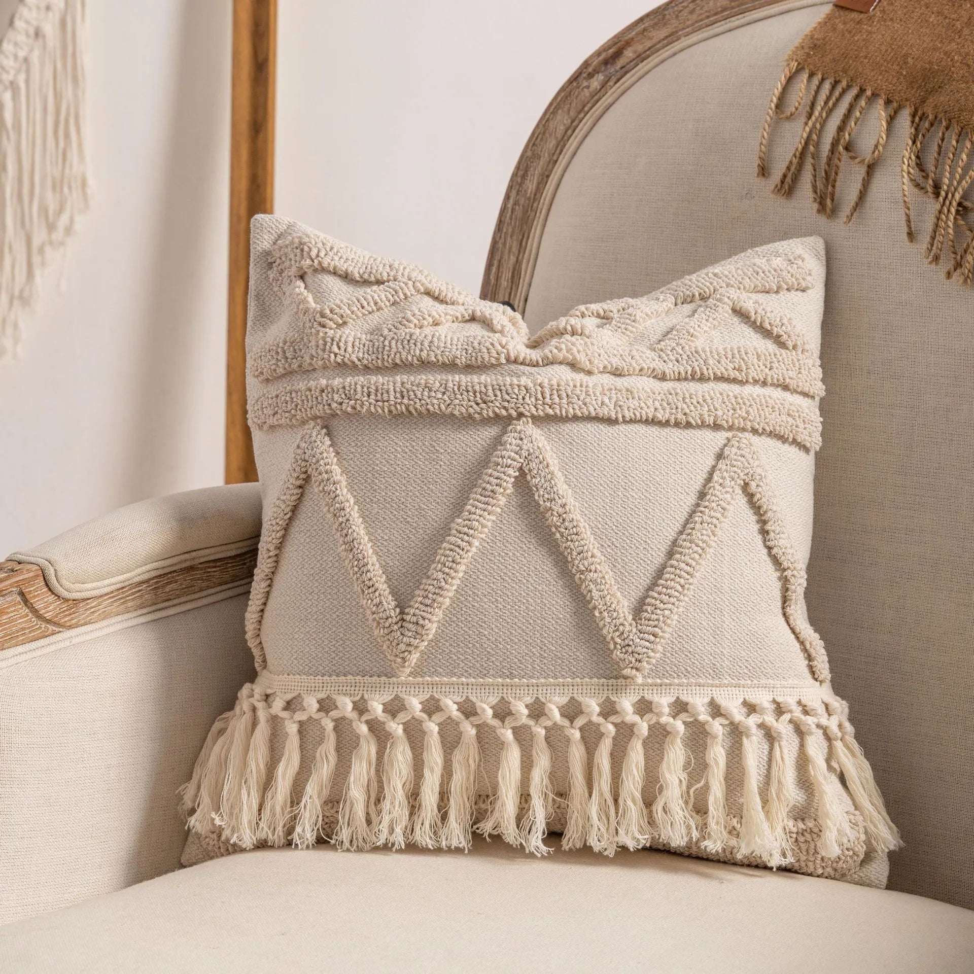 Knitted striped cushion cover with tassel detail in spiral dots design, shown in 45x45cm size.