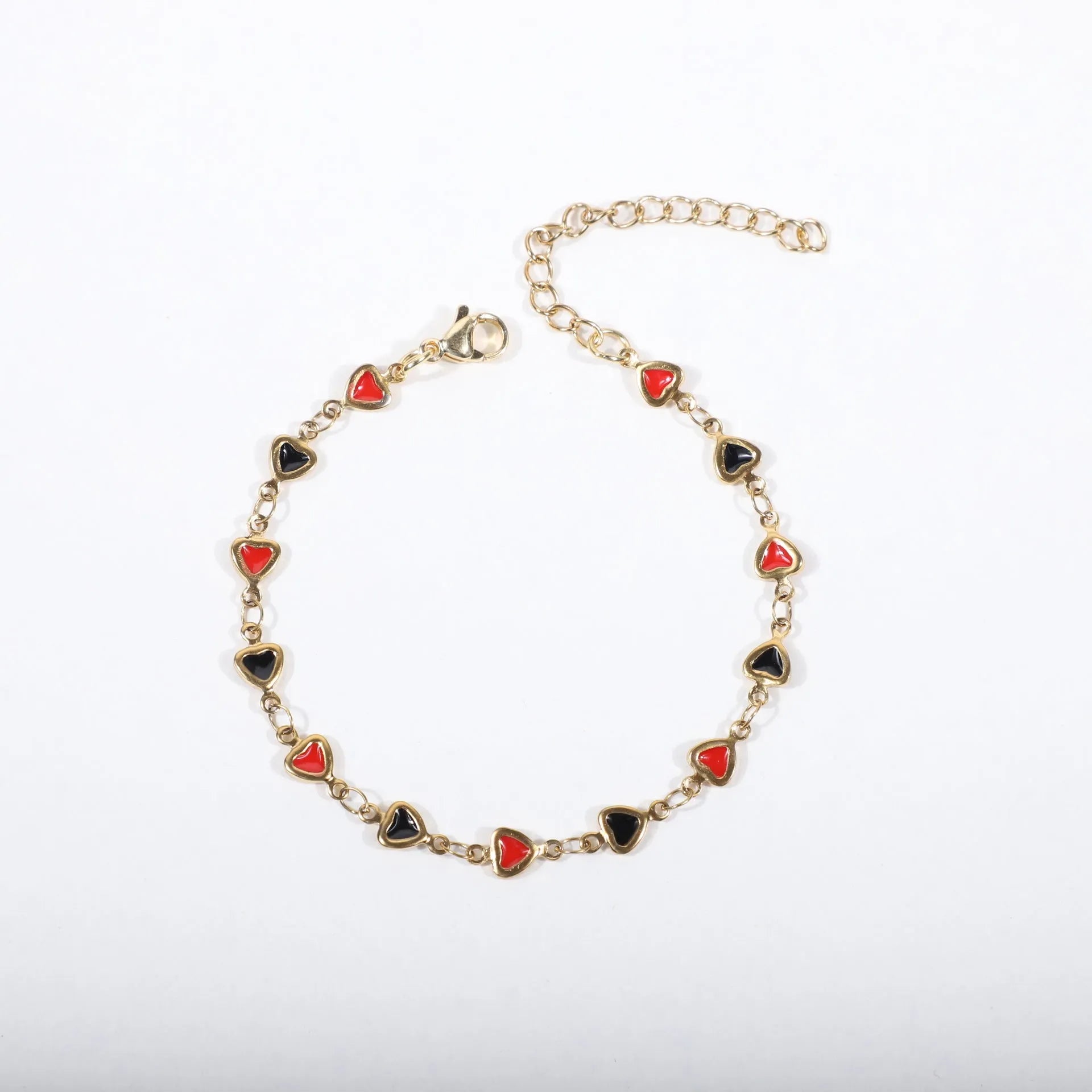 Stainless steel heart-shaped bracelet with 18K gold colour plating on a wrist, showing adjustable 17+5cm length.