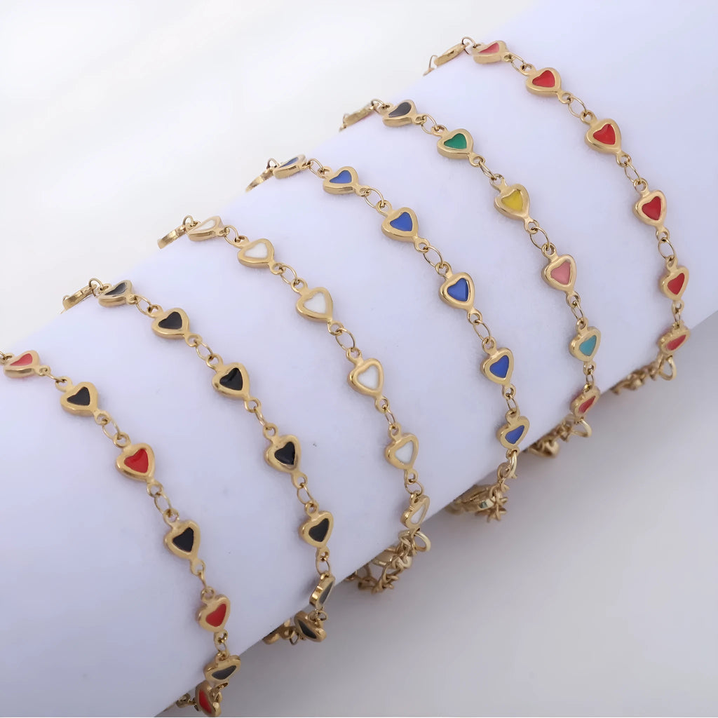 Stainless steel heart-shaped bracelet with 18K gold colour plating on a wrist, showing adjustable 17+5cm length.