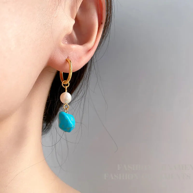 Geometric irregular shaped copper clip-on earrings with turquoise stones and cultured pearls.
