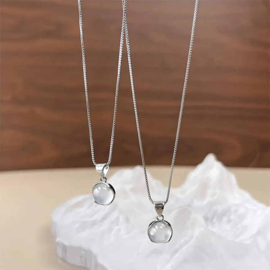 Women's oval artificial crystal pendant necklace with eight-point star design on an adjustable box chain.