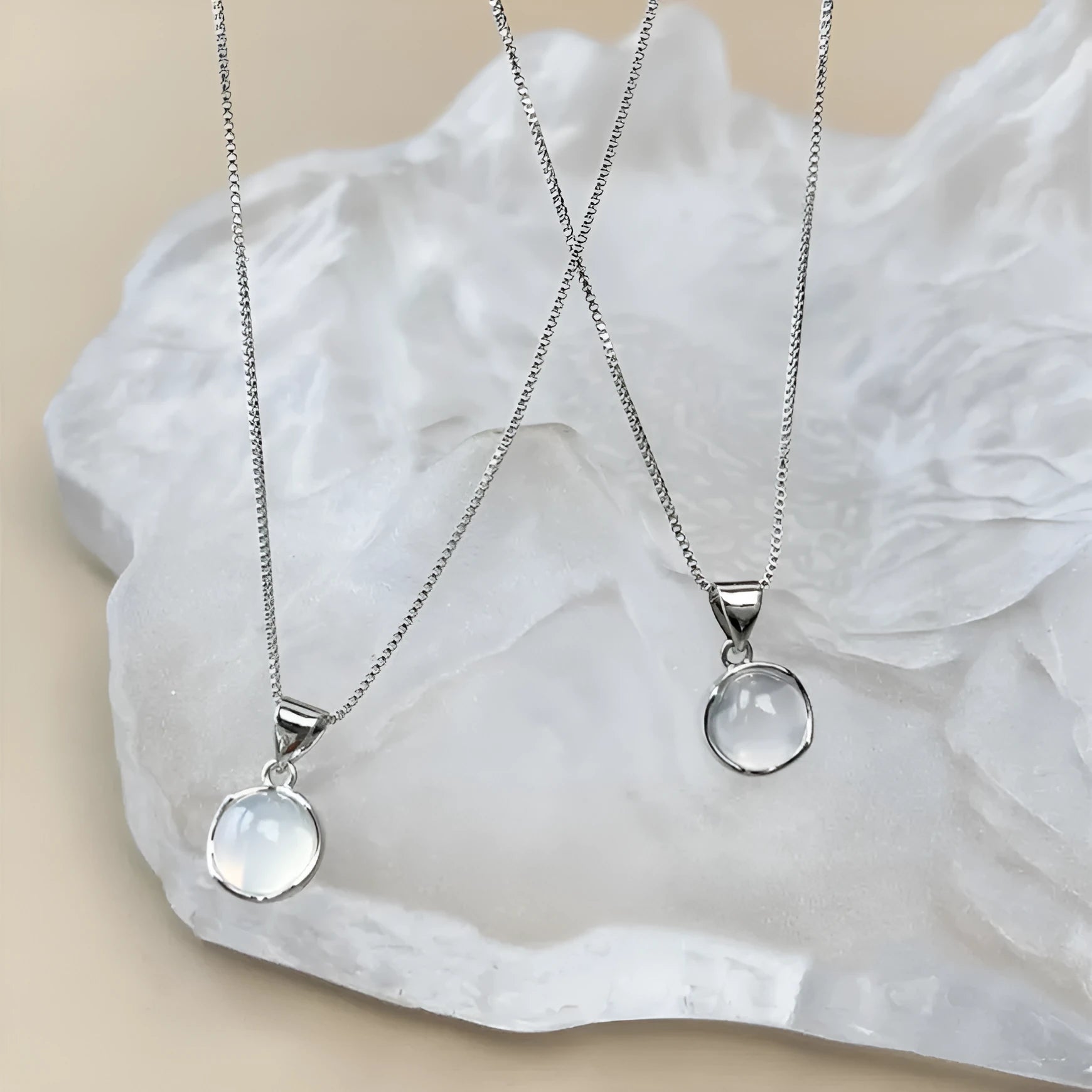 Women's oval artificial crystal pendant necklace with eight-point star design on an adjustable box chain.