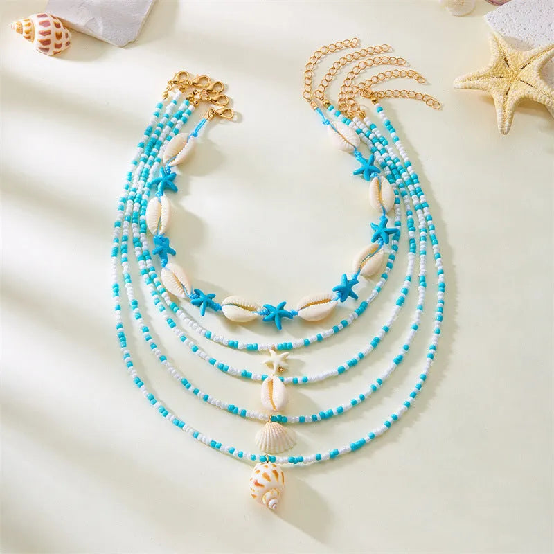 Five-piece women's necklace set with shell beads and adjustable chains in blue and coloured variations