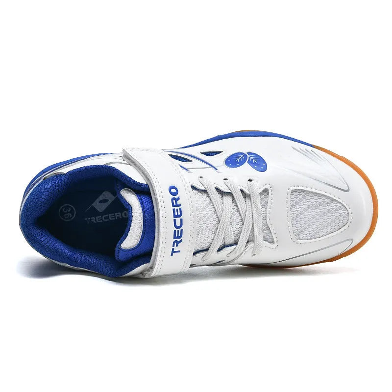 White and blue low-top casual badminton shoes with ribbed sole on a court surface.