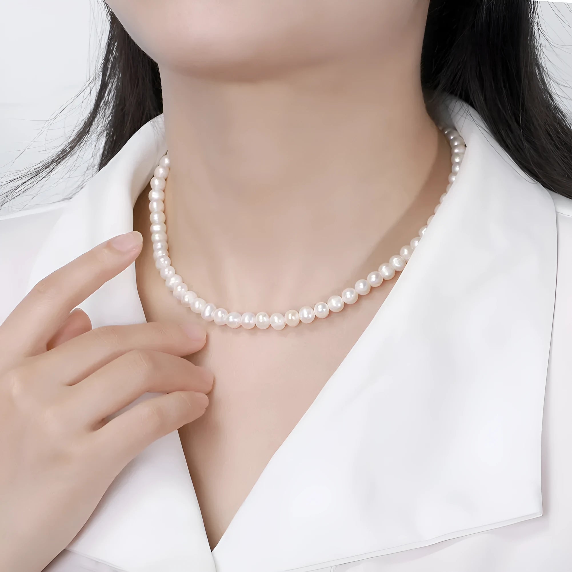 Women's simple adjustable necklace with natural freshwater pearls on a sterling silver chain.