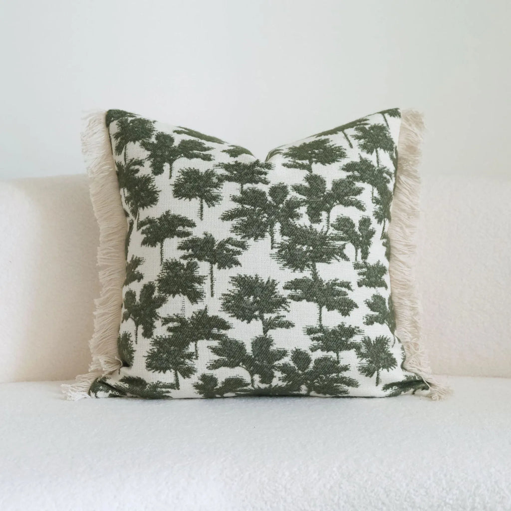 Green striped and botanical pattern decorative pillow set with tassel detail for hotel sample rooms.
