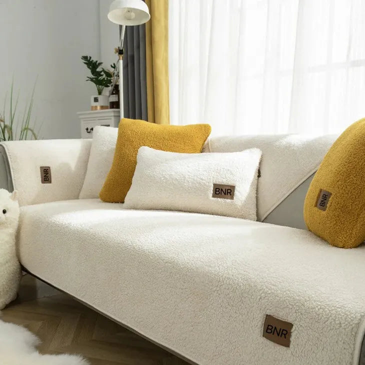 Lambswool sofa slipcover in blue on a three-seater sofa with matching cushion cover.