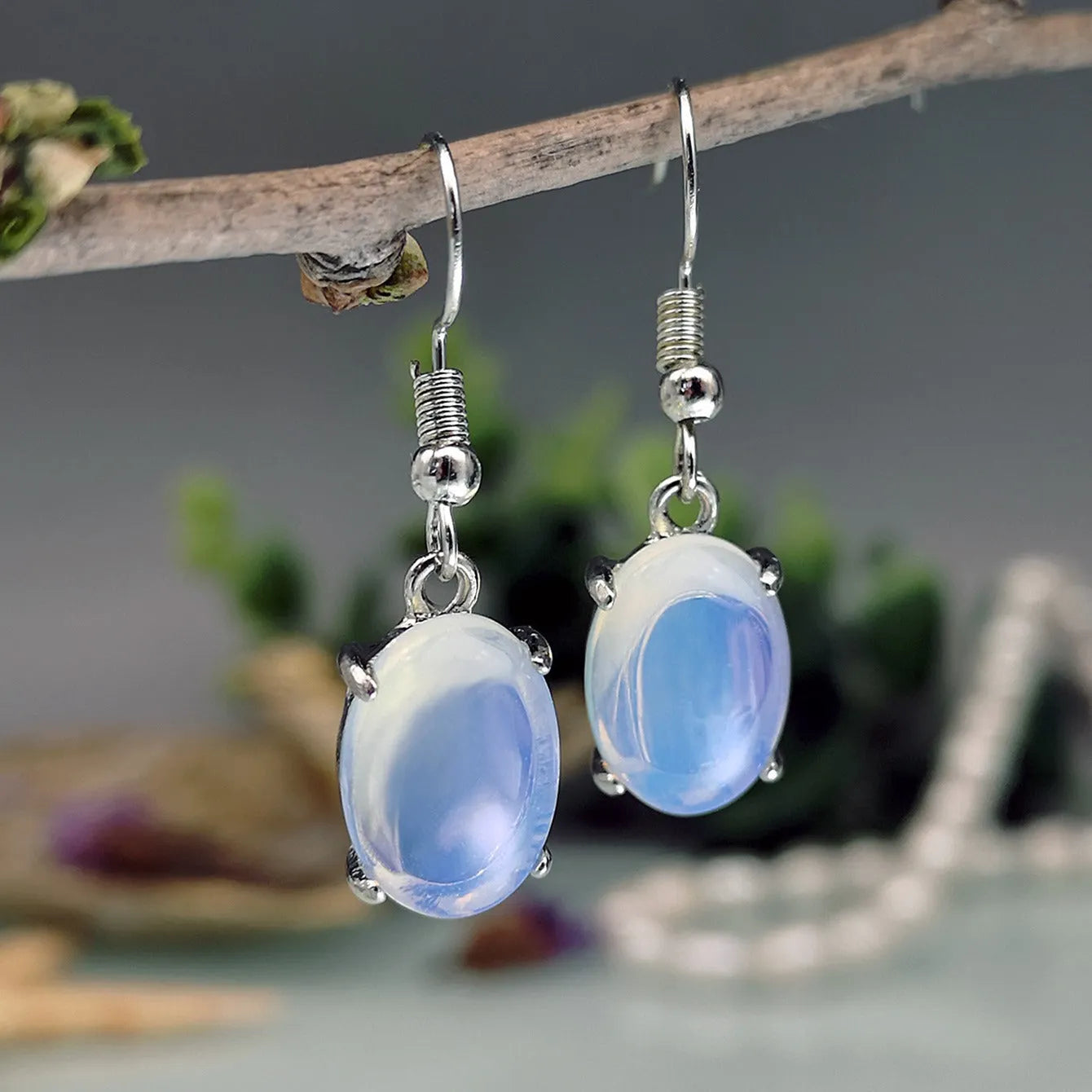 Moonlight white opal earrings with cross shaped drop design and retro moonstone appearance