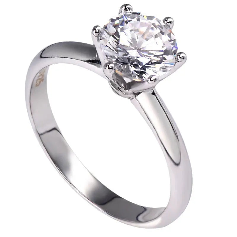 White gold plated zircon ring with six-claw setting and geometric shape on finger