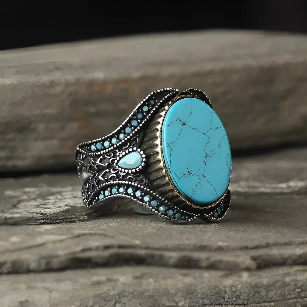 Men's round turquoise ring in antique silver alloy showing simple design and stone setting