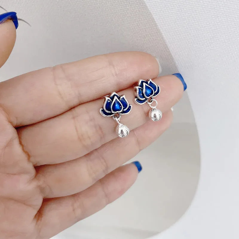 Blue Lotus earrings with a flower stud and dangling seedpod tassel in silver-tone alloy.