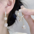 Women's silver-toned drop earrings with a double pendant and rhinestone ball tassel on an ear clip.
