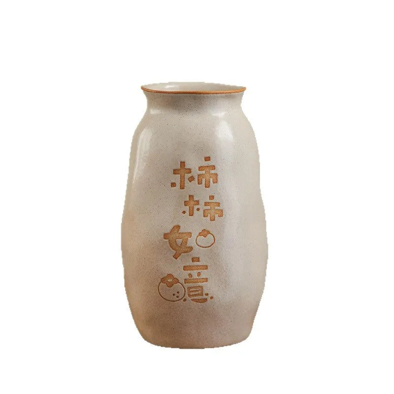 Chinese hand-painted ceramic vase with carved design on wooden desktop
