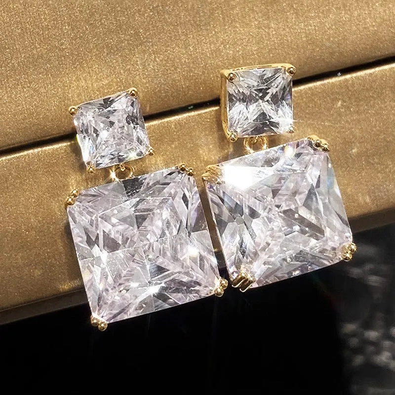 A pair of geometric square-shaped copper earrings for women, shown in gold and white gold colour options.