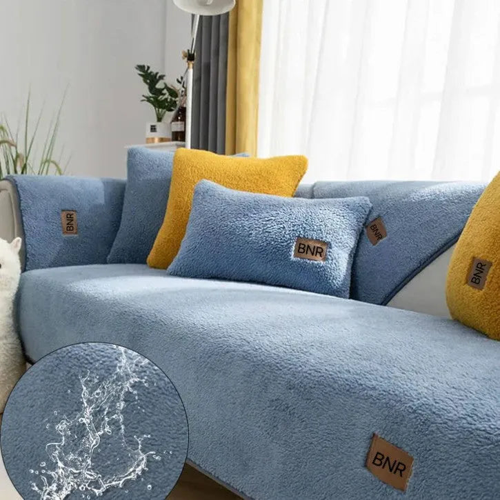 Lambswool sofa slipcover in blue on a three-seater sofa with matching cushion cover.