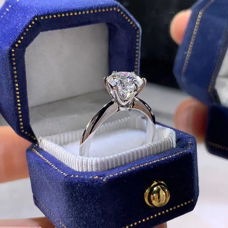White gold plated zircon ring with six-claw setting and geometric shape on finger