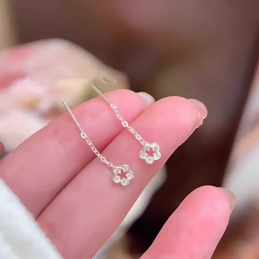 Silver colour hollow flower stud earrings with petal design on alloy posts