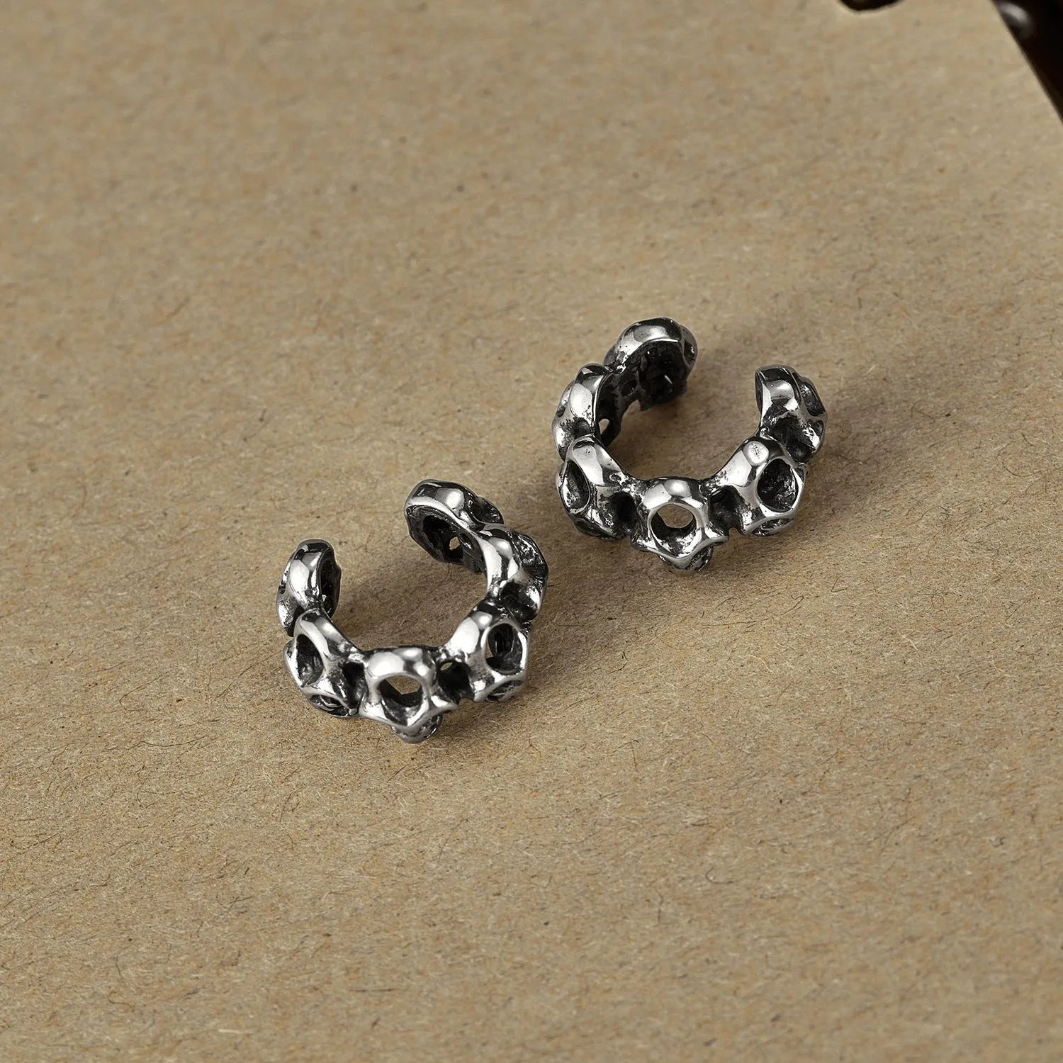 Retro geometric skull earrings in stainless steel with ear clip fitting.