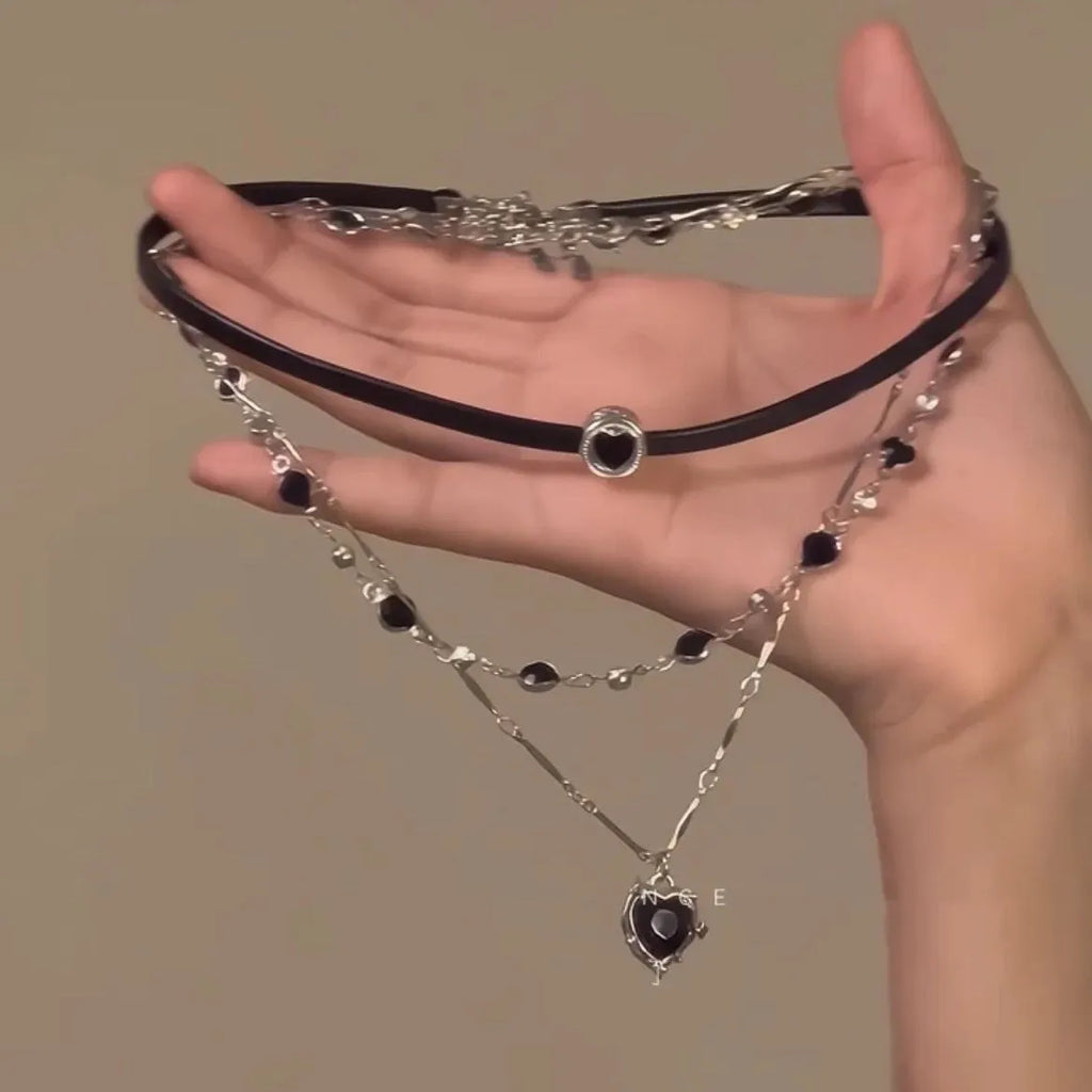 Women's creative necklace set showing a double-layer leather heart necklace and a single crystal heart pendant on a metal chain.