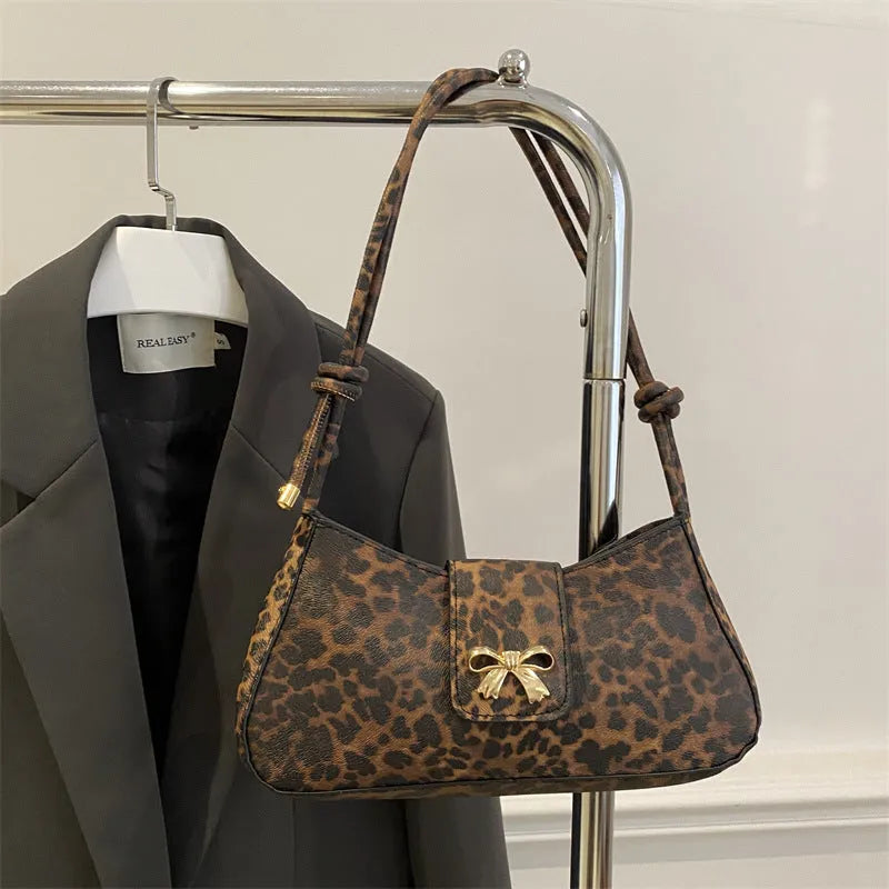 Casual women's PU handbag with sandwich pocket organisation in black colour showing 27 cm width