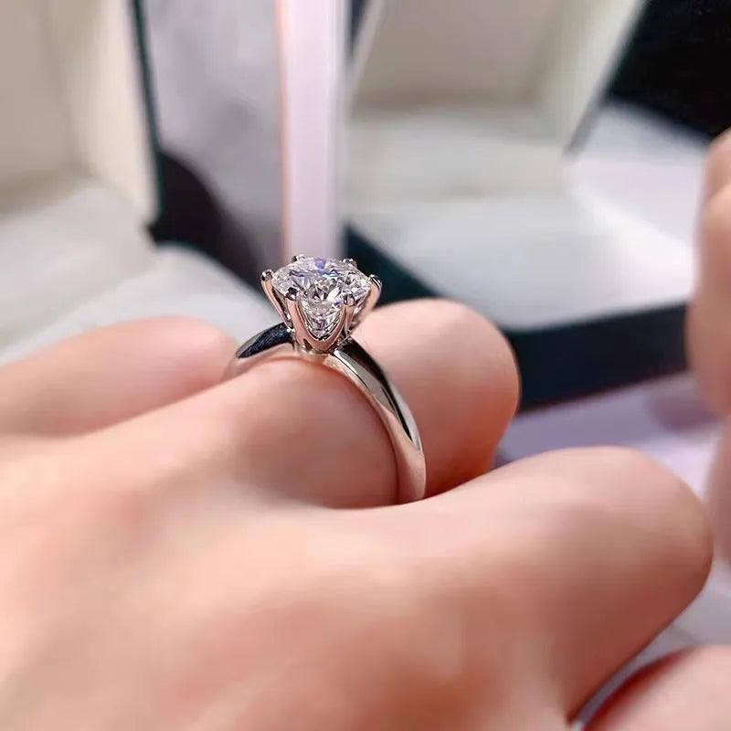 White gold plated zircon ring with six-claw setting and geometric shape on finger