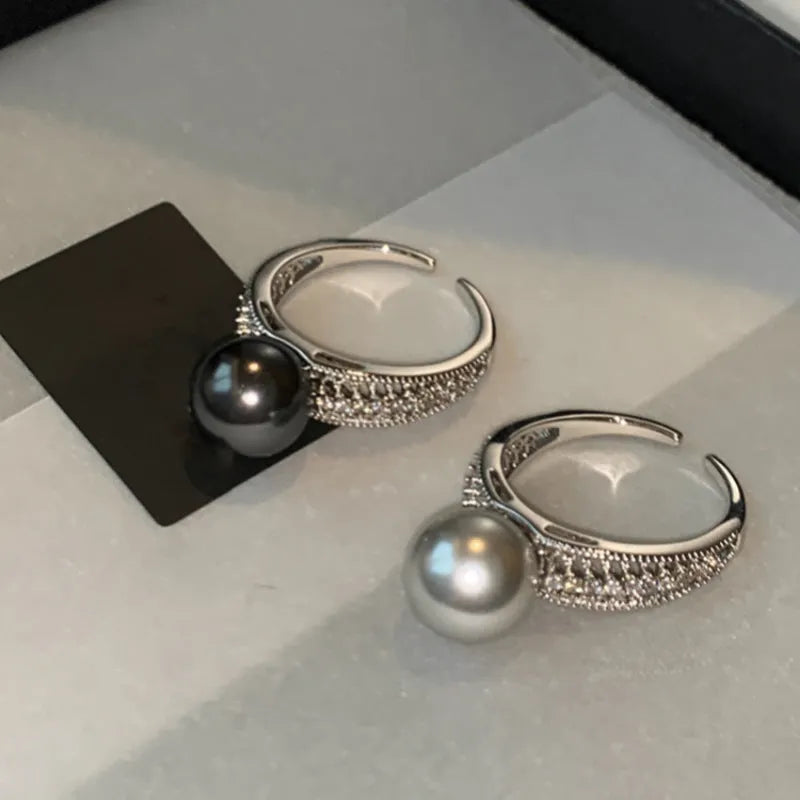 Women's adjustable open ring with geometric design and black pearl finish on copper.