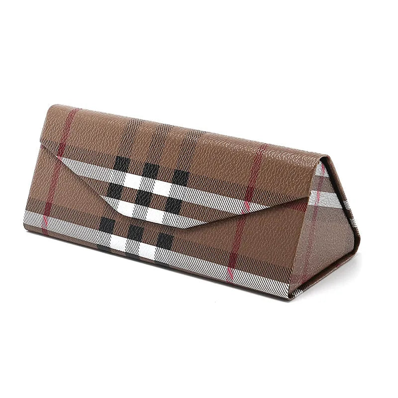 Handmade black PU cowhide triangular folding glasses case open next to a pair of spectacles.