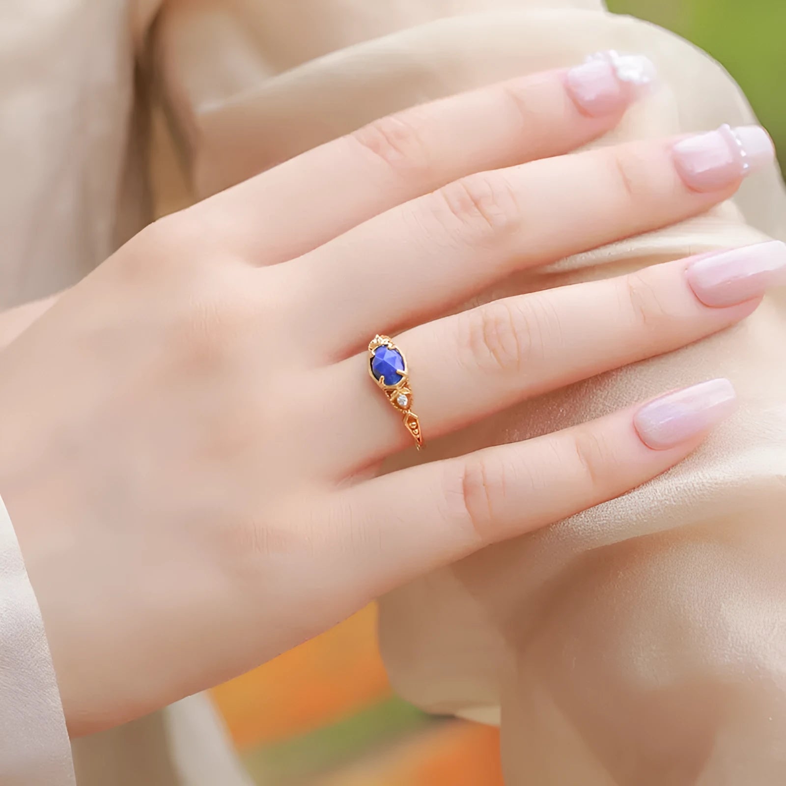 Japanese style silver alloy ring with blue elliptical lapis lazuli stone and geometric design.