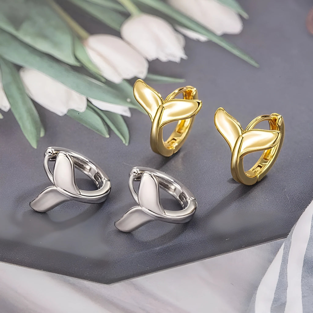 Women's copper fishtail design earrings in white gold or yellow gold colour.