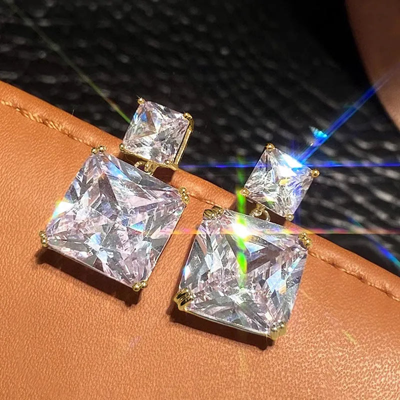 A pair of geometric square-shaped copper earrings for women, shown in gold and white gold colour options.