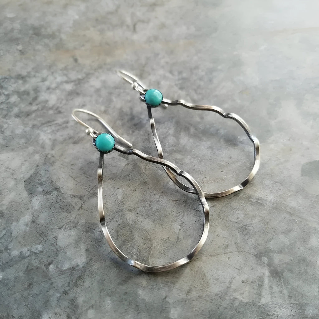 A pair of vintage-style bohemian circle earrings in antique silver alloy with turquoise colour accents.